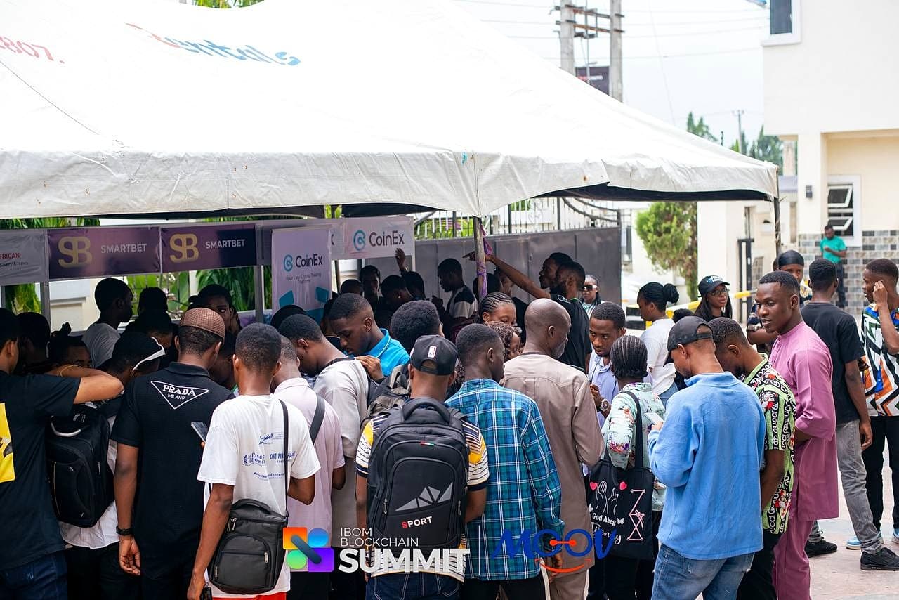Attendees queuing at the CoinEx and SmartBet booths at IBX Summit